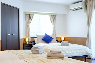 a bedroom with two beds with towels on them at Penthouse Apartment with Skytree View - 94sqm Luxury Suite - Miilo ASAKUSA EAST in Tokyo