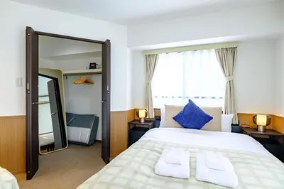 a bedroom with a large bed and a mirror at Penthouse Apartment with Skytree View - 94sqm Luxury Suite - Miilo ASAKUSA EAST in Tokyo