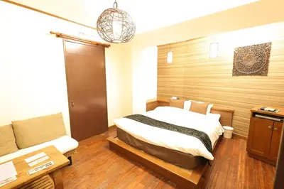 a bedroom with a bed and a couch at HOTEL B-Girl in Tokyo