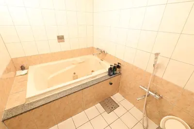 a bathroom with a bath tub and a toilet at HOTEL B-Girl in Tokyo