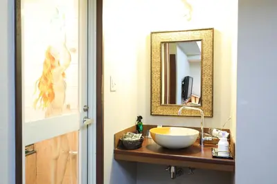 a bathroom with a sink and a mirror at HOTEL B-Girl in Tokyo