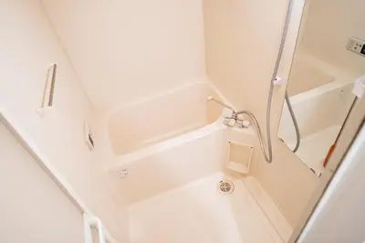 a shower in a small bathroom with white walls at Shinjuku ,2 minutes from the station in Tokyo