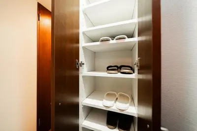a closet with two pairs of shoes on shelves at Shinjuku ,2 minutes from the station in Tokyo