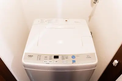 a white toilet in a corner of a bathroom at Shinjuku ,2 minutes from the station in Tokyo