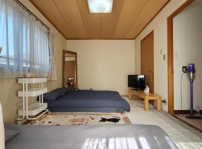 a bedroom with a bed and a tv in it at live in Onsen in Tokyo