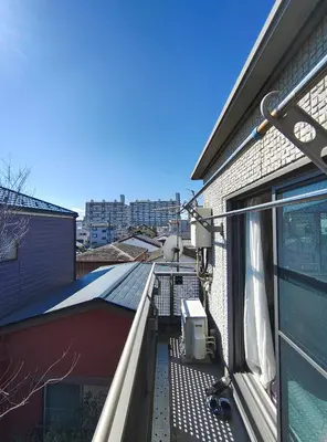 an outdoor balcony with a view of a building at live in Onsen in Tokyo