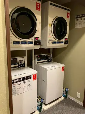 three washing machines are on a shelf in a room at \u7537\u6027\u5c02\u7528-Male Only \u30b5\u30af\u30fc\u30ec\u516b\u5e83 in Tokyo