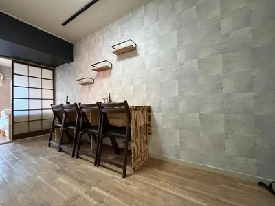 a bar with chairs against a brick wall at Doragon House in Tokyo
