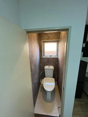 a bathroom with a toilet in a small room at Doragon House in Tokyo