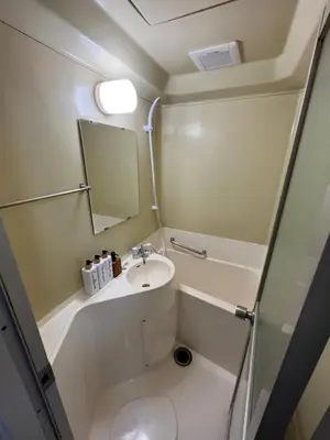 a small bathroom with a sink and a mirror at Doragon House in Tokyo