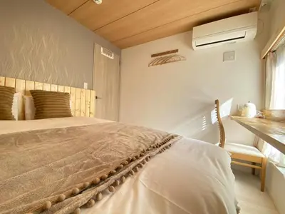 a bedroom with a large bed and a window at N5-Guest House in Tokyo ShinKoiwa in Tokyo
