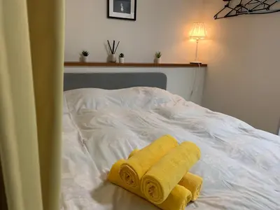 a bed with two yellow towels on it at Holiday Anytel Shinjuku#1 in Tokyo