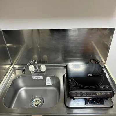 a kitchen counter with a sink and a toaster oven at Holiday Anytel Shinjuku#1 in Tokyo