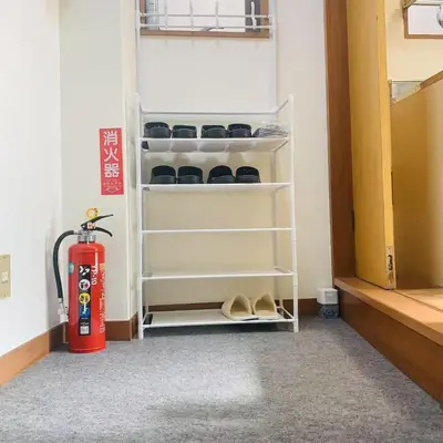 a room with a fire hydrant and some shelves at Japan House \u6e6f\u5cf6 in Tokyo