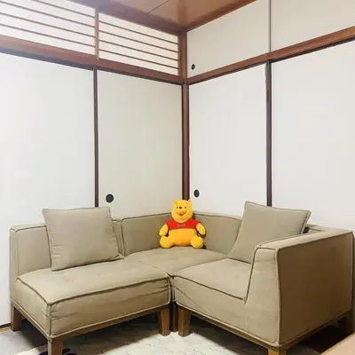 a teddy bear sitting on a couch in a room at Japan House \u6e6f\u5cf6 in Tokyo
