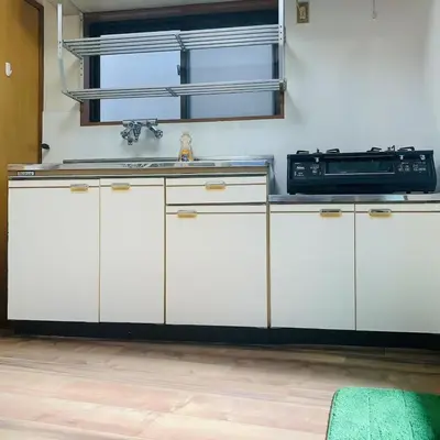 a kitchen with white cabinets and a sink and a microwave at Japan House \u6e6f\u5cf6 in Tokyo