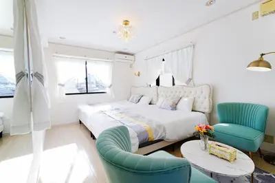 a bedroom with a bed and a table and chairs at European villa in Tokyo