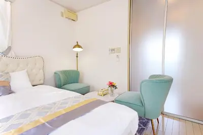 a bedroom with two chairs and a bed at European villa in Tokyo