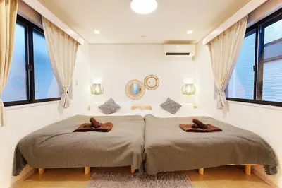 a bedroom with a bed with two brown slippers at European villa in Tokyo
