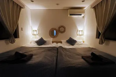 a large bed in a bedroom with two lights at European villa in Tokyo