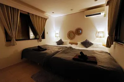 a bedroom with a large bed with shoes on it at European villa in Tokyo