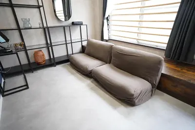 a leather couch in a living room with a window at Hotel iemirai SHINJUKU 3min train ride to Shinjuku Station in Tokyo
