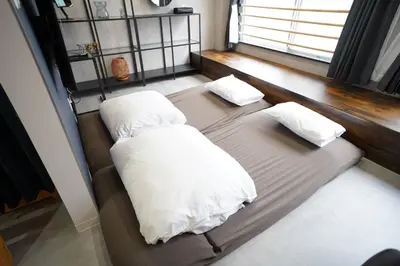 a bed with two pillows on it in a room at Hotel iemirai SHINJUKU 3min train ride to Shinjuku Station in Tokyo