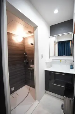 a bathroom with a shower and a sink at Hotel iemirai SHINJUKU 3min train ride to Shinjuku Station in Tokyo