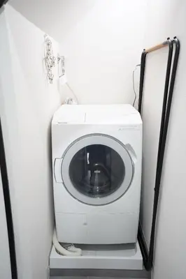 a washer and dryer sitting in a room at Hotel iemirai SHINJUKU 3min train ride to Shinjuku Station in Tokyo