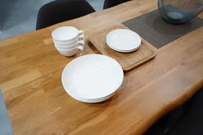 three white plates sitting on a wooden table at Hotel iemirai SHINJUKU 3min train ride to Shinjuku Station in Tokyo