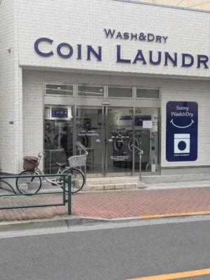 a store front of a store with a bike parked outside at Cozy stay with direct access to Narita & Haneda in Tokyo