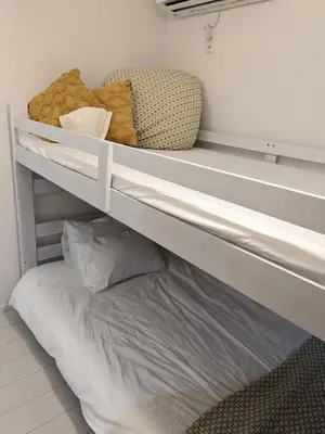 a bunk bed in a room with a pillow at Cozy stay with direct access to Narita & Haneda in Tokyo