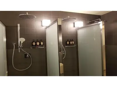 a bathroom with two mirrors and a shower and a sink at GLANSIT AKIHABARA