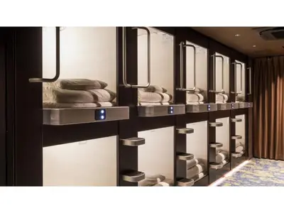 a row of sinks in a bathroom with towels at GLANSIT AKIHABARA