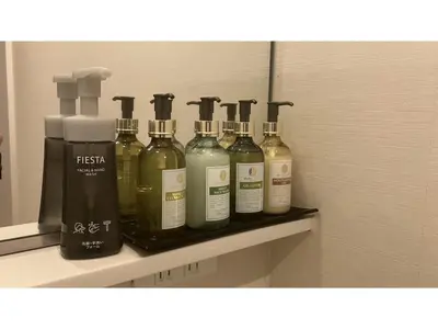a shelf with four bottles of alcohol on it at GLANSIT AKIHABARA