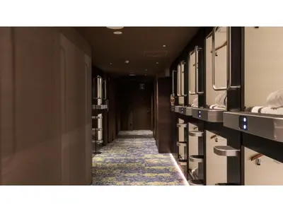a corridor of a hotel with sinks and towels at GLANSIT AKIHABARA