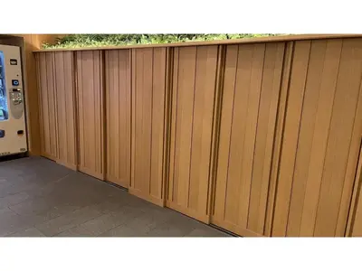 a wooden fence with plants on top of it at GLANSIT AKIHABARA
