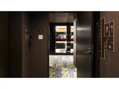 an open door in a room with a hallway at GLANSIT AKIHABARA