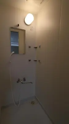 a bathroom with a shower with a light on the wall at Holiday Anytel Shinjuku#2 in Tokyo