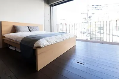 a bedroom with a bed and a large window at Grass BLDG 301 in Tokyo