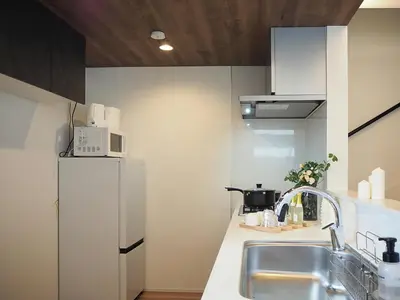 a kitchen with a sink and a refrigerator at \u685c\u306e\u5ddd64 \u6c60\u888b\u99c5C6\u53e3 8\u5206 2-11\u4eba\u4e28Ikebukuro JR Line C6 Exit 8 minutes 2-11 people in Tokyo