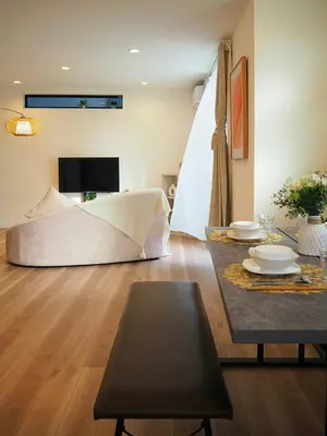 a living room with a bed and a table at \u685c\u306e\u5ddd64 \u6c60\u888b\u99c5C6\u53e3 8\u5206 2-11\u4eba\u4e28Ikebukuro JR Line C6 Exit 8 minutes 2-11 people in Tokyo