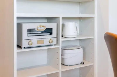 a white cabinet with a toaster oven and a toaster at House hotel EKODA 301 HE31 in Tokyo