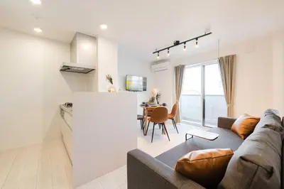 a living room and kitchen with a couch and a table at House hotel EKODA 301 HE31 in Tokyo