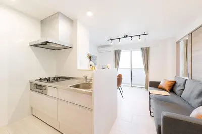 a white kitchen with a sink and a couch at House hotel EKODA 301 HE31 in Tokyo