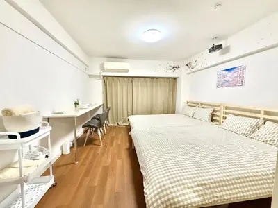 a bedroom with two beds and a desk at Shinjuku Waseda\u30cf\u30a6\u30b9 t2 in Tokyo