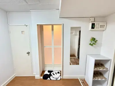 a room with a glass door and a dog laying on the floor at Shinjuku Waseda\u30cf\u30a6\u30b9 t2 in Tokyo