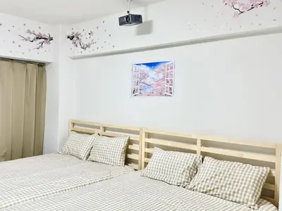 two beds sitting next to each other in a bedroom at Shinjuku Waseda\u30cf\u30a6\u30b9 t2 in Tokyo