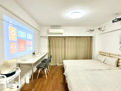 a small room with two beds and a desk and a desk at Shinjuku Waseda\u30cf\u30a6\u30b9 t2 in Tokyo