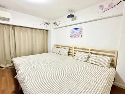 a bedroom with two beds and a window at Shinjuku Waseda\u30cf\u30a6\u30b9 t2 in Tokyo